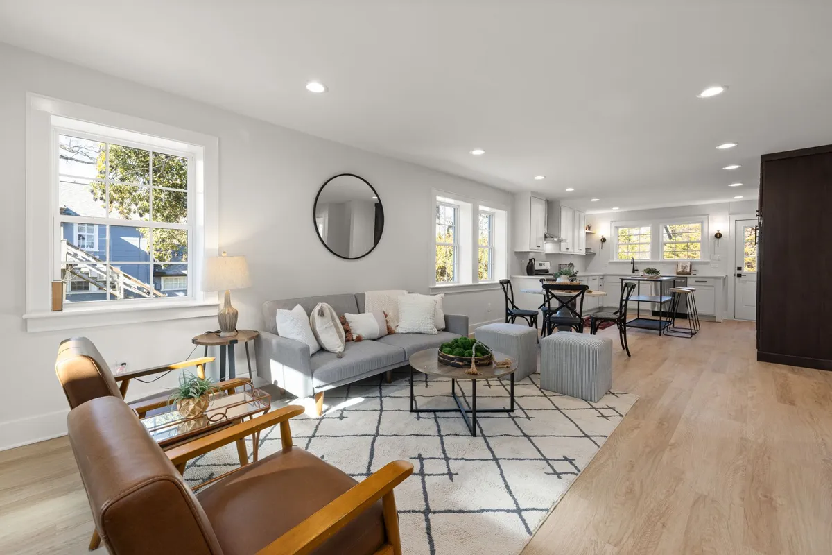 A living room with carefully arranged furniture, showcasing a staged space for a quick home sale.